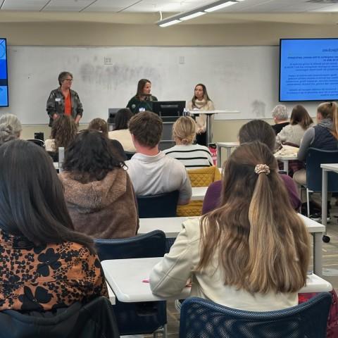 Three UNE occupational therapists give a classroom presentation